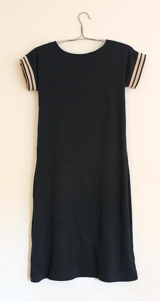 Sailor inspired dress in Navy blue with cream and navy striped trimming around the arm holes.