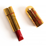 Red lipstick in a gold tube with red flowers